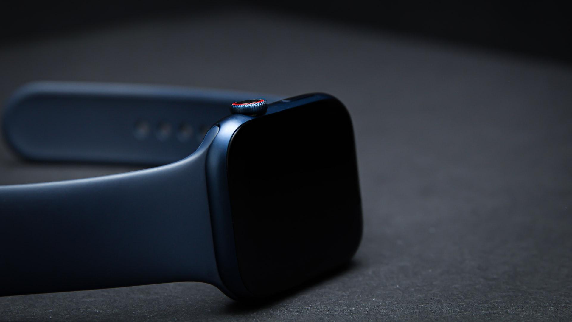 black smart watch on gray surface